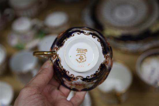 A collection of 19th century floral painted teaware and a French gilt decorated two handled vase